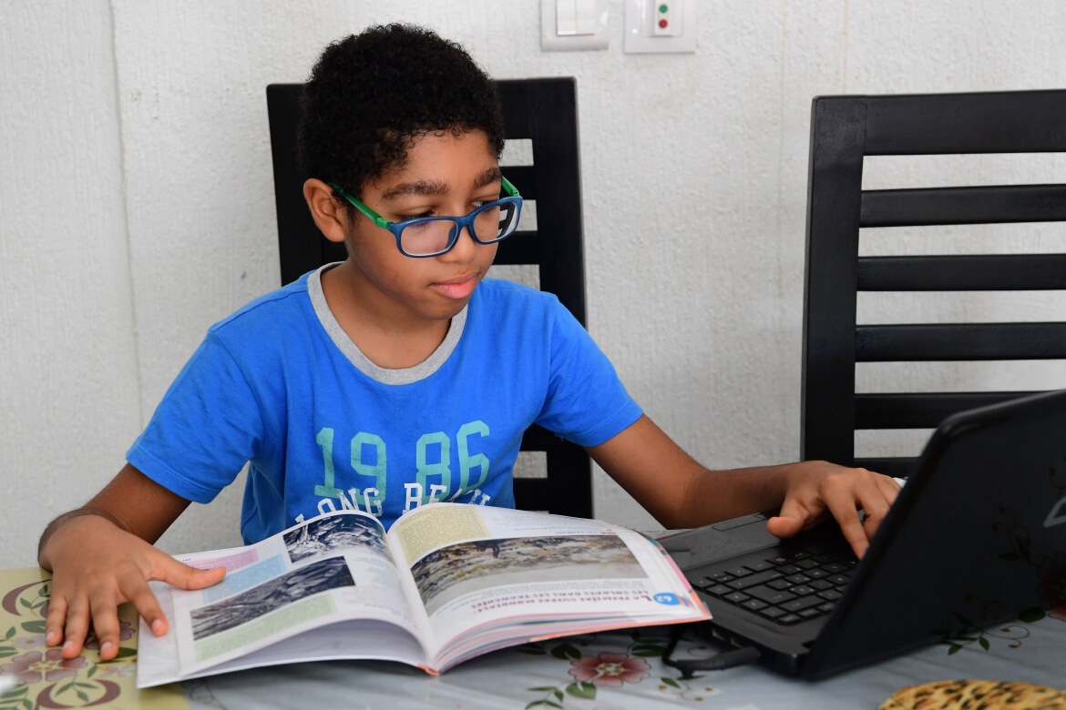 Noah Urrea, a 10-year-old boy in Côte d'Ivoire, studying using “My School at Home”.