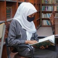 Malak, a 16-year-old secondary school student, reads a book in the library of Aden Model School, which received a school grant, in Aden, Yemen. Credit: UNICEF/UN0620706/Fuad